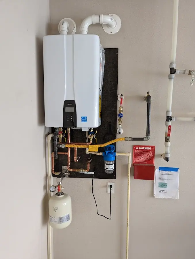 Professional plumber installing copper piping in a Belmont home